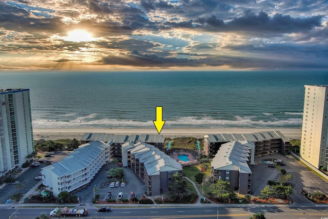 drone / aerial view featuring a beach view and a water view