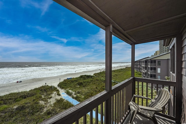 balcony with a view of the beach and a water view
