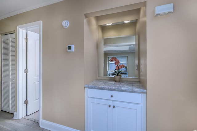 hall featuring crown molding and baseboards