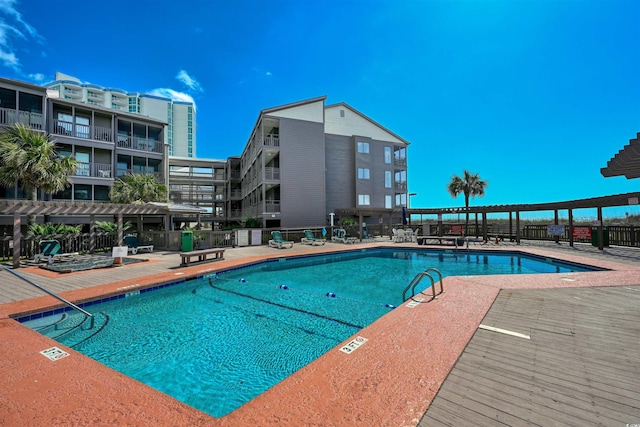 pool with a patio, fence, and a pergola
