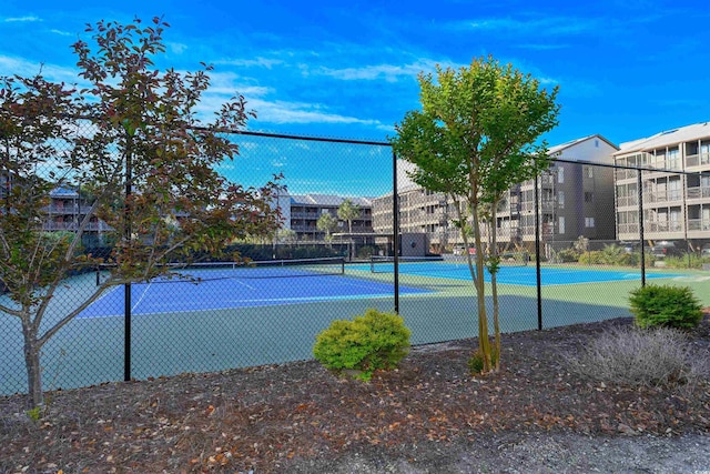 view of tennis court featuring fence
