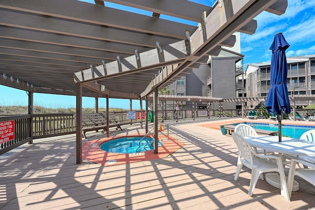 community pool with a pergola and a community hot tub