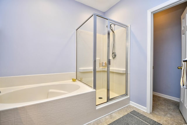 full bathroom featuring tile patterned floors, a stall shower, and a bath