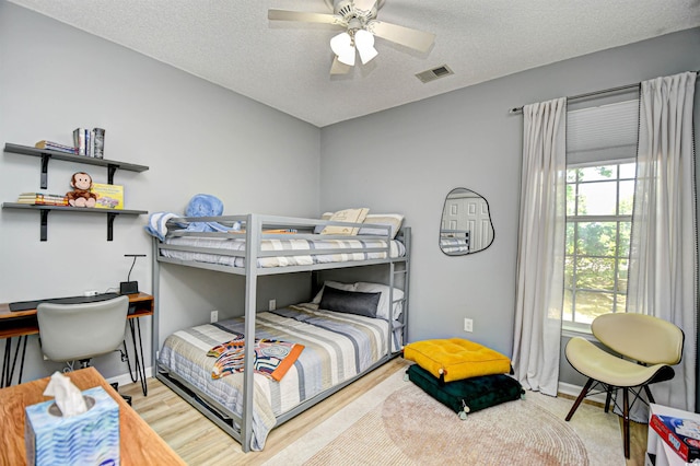 5813 Mossy Oaks Dr, North Myrtle Beach, SC 29582 - bedroom featuring visible vents, a ceiling fan, and a textured ceiling