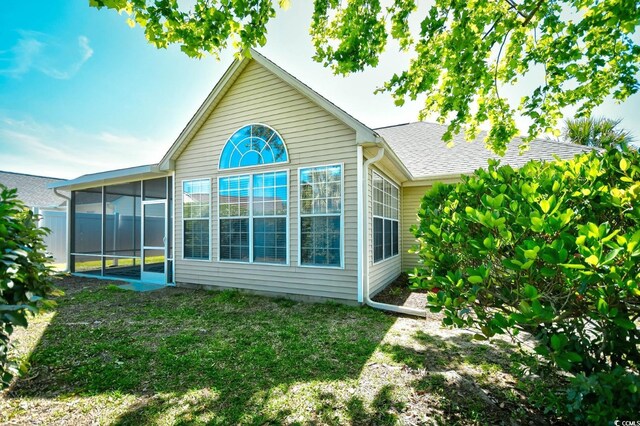 5813 Mossy Oaks Dr, North Myrtle Beach, SC 29582 - back of house with a yard and a sunroom