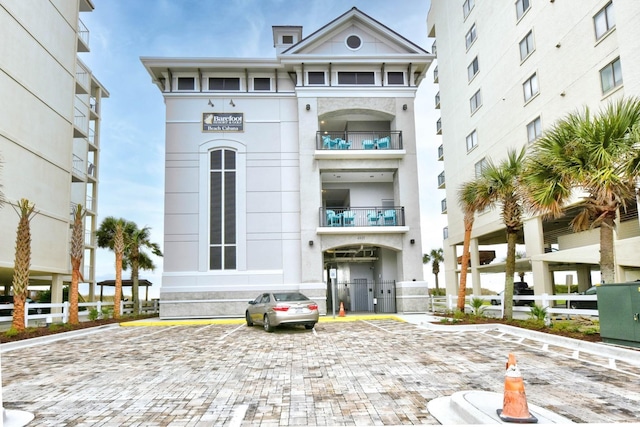 view of building exterior with uncovered parking