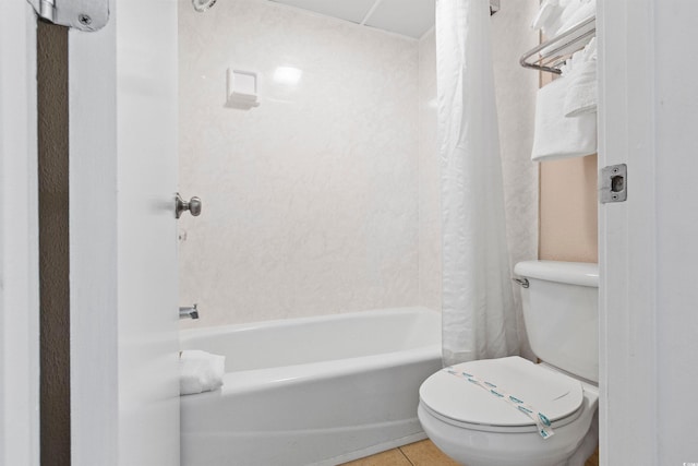bathroom featuring toilet, tile patterned flooring, and shower / bath combo with shower curtain