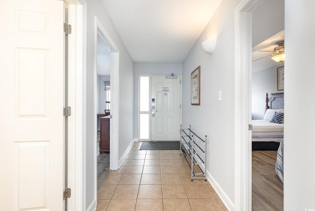 foyer with baseboards and light tile patterned flooring