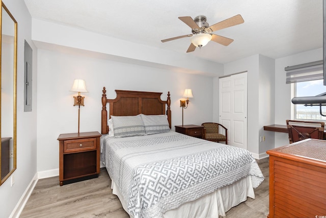 bedroom with baseboards, ceiling fan, and wood finished floors