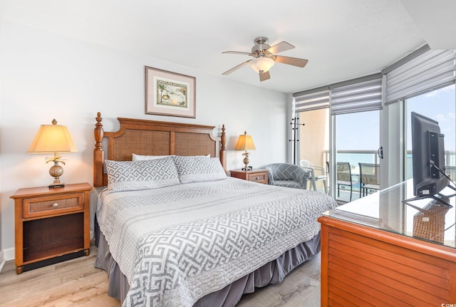 bedroom featuring access to outside, a ceiling fan, and wood finished floors