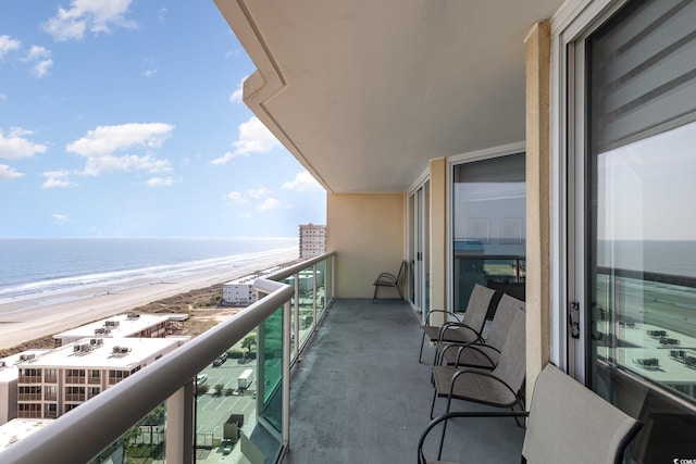 balcony with a beach view and a water view