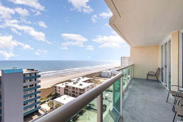 balcony with a view of the beach and a water view