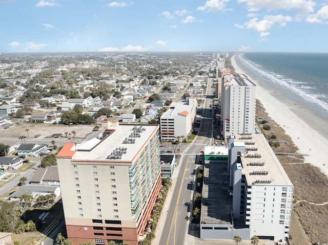 drone / aerial view with a water view and a beach view