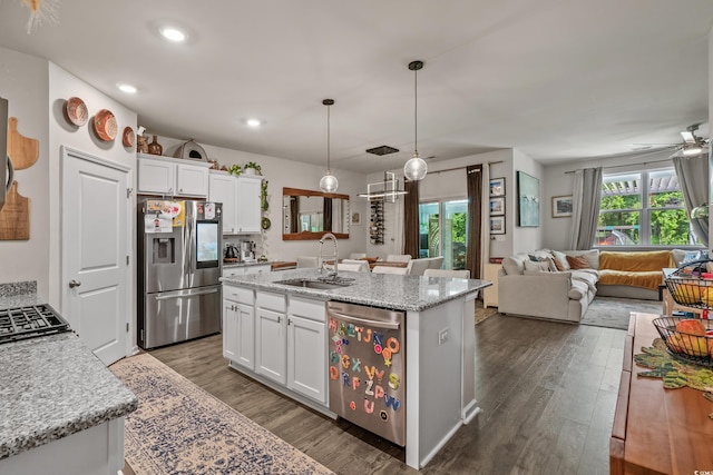 1011 Maxwell Dr, Little River, SC 29566 - kitchen with a sink, dark wood finished floors, stainless steel appliances, open floor plan, and white cabinetry