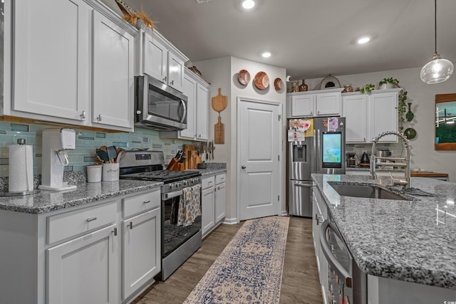 1011 Maxwell Dr, Little River, SC 29566 - kitchen featuring pendant lighting, tasteful backsplash, a sink, stainless steel appliances, and white cabinetry