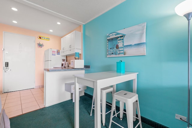 6803 N Ocean Blvd Unit 328, Myrtle Beach, SC 29572 - kitchen with white appliances, recessed lighting, white cabinetry, a peninsula, and tile patterned floors