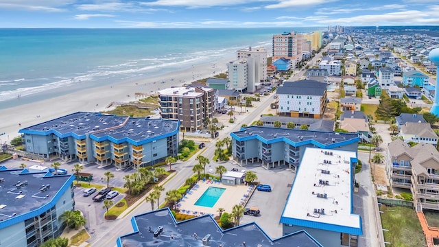 bird's eye view featuring a water view and a view of the beach