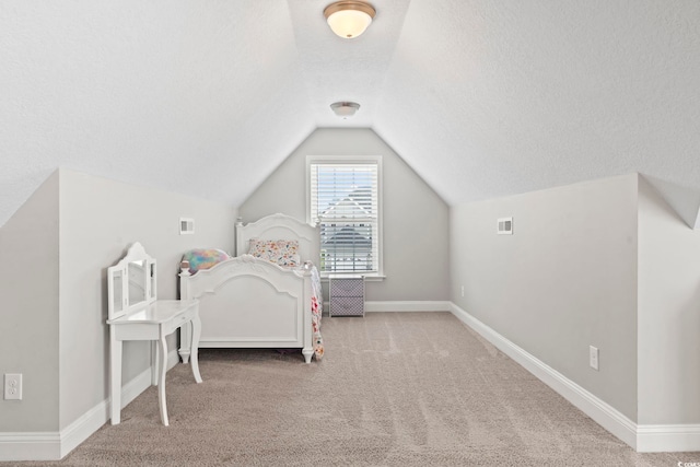 bedroom featuring vaulted ceiling, carpet flooring, and visible vents