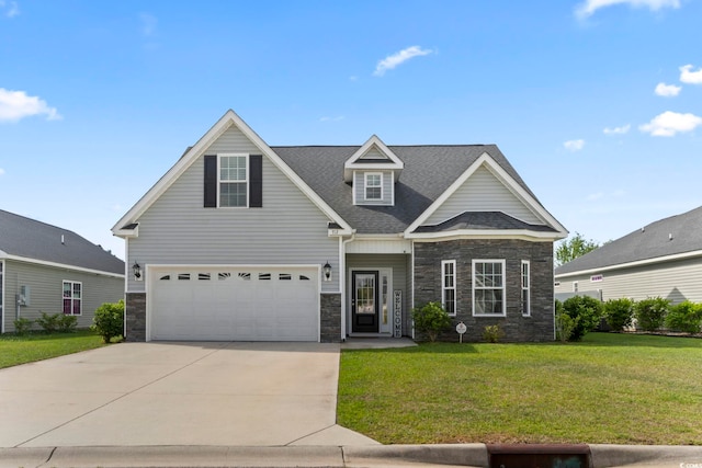 craftsman-style house with roof with shingles, a front yard, concrete driveway, an attached garage, and stone siding