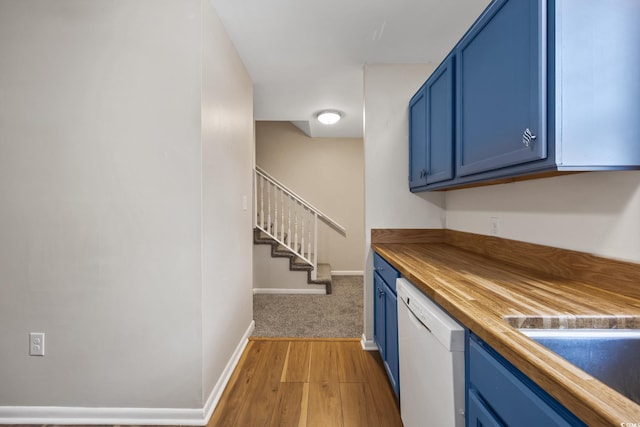bar with baseboards, stairway, a sink, light wood finished floors, and dishwasher