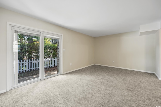 empty room with carpet floors and baseboards