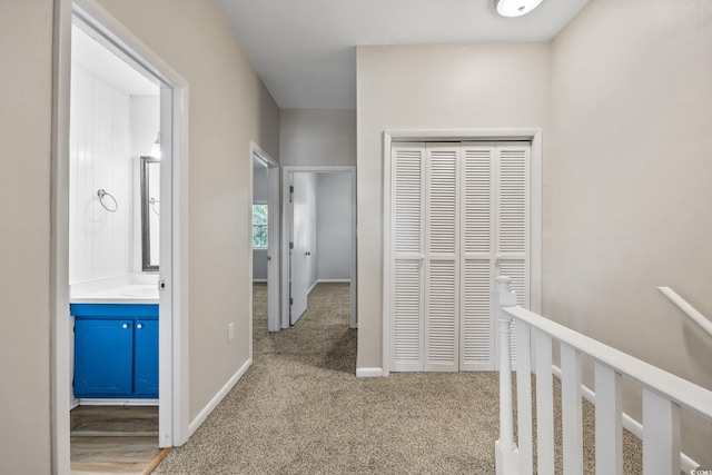 hall with carpet floors and baseboards