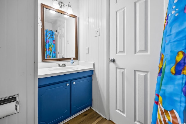 bathroom with wood finished floors and vanity