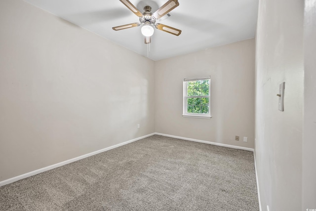 carpeted spare room with baseboards and ceiling fan