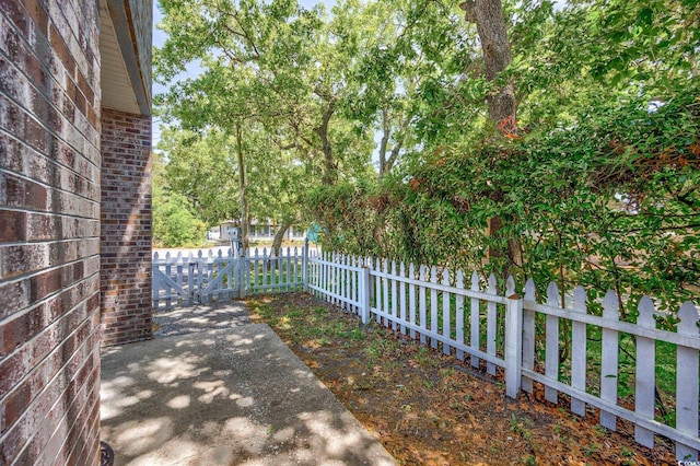 2701 Hillside Dr S Unit 1, North Myrtle Beach, SC 29582 - fenced yard featuring a gate