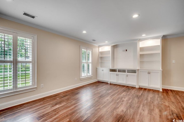107 Azalea Dr, Conway, SC 29526 - unfurnished living room with crown molding, light wood-style flooring, and a healthy amount of sunlight