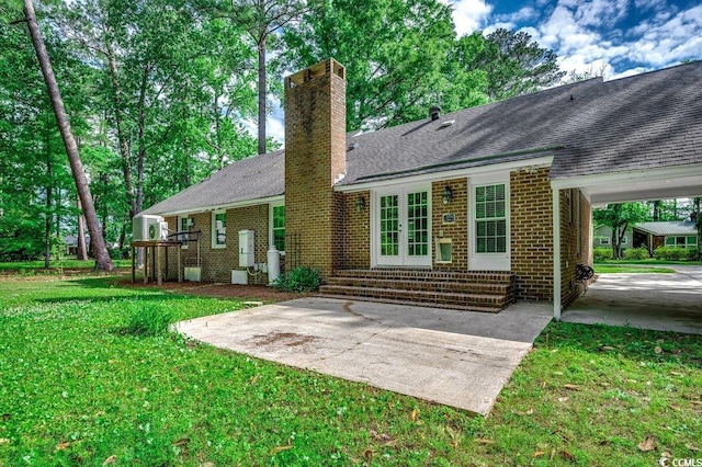 107 Azalea Dr, Conway, SC 29526 - rear view of property with roof with shingles, brick siding, entry steps, a chimney, and a lawn