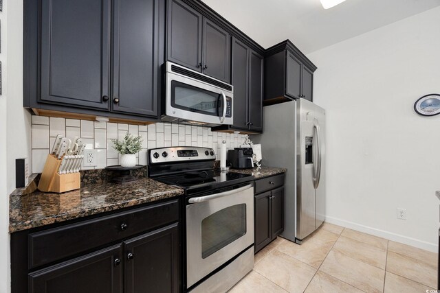 903 Ocean Pines Ct, North Myrtle Beach, SC 29582 - kitchen featuring appliances with stainless steel finishes, dark stone counters, baseboards, light tile patterned floors, and tasteful backsplash