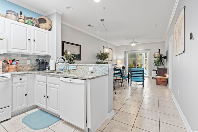 kitchen with a peninsula, white appliances, white cabinetry, a sink, and light tile patterned floors