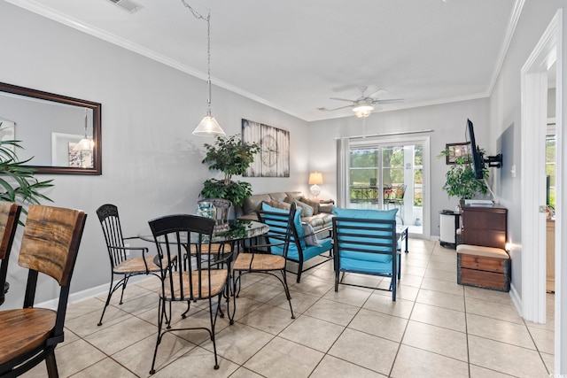dining area with crown molding, ceiling fan, and light tile patterned floors