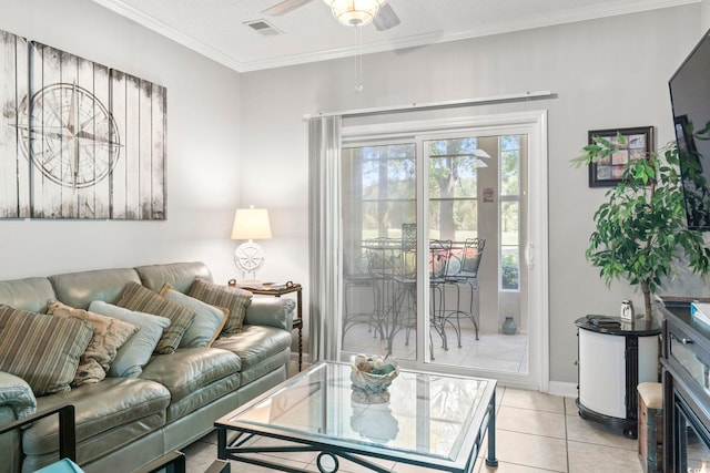living area with a ceiling fan, visible vents, light tile patterned floors, baseboards, and ornamental molding