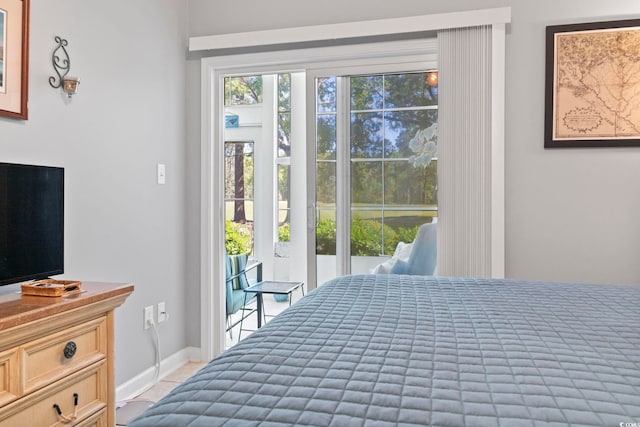 bedroom featuring baseboards and access to exterior