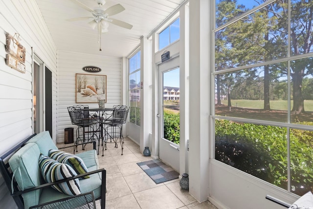 sunroom / solarium with ceiling fan and a wealth of natural light
