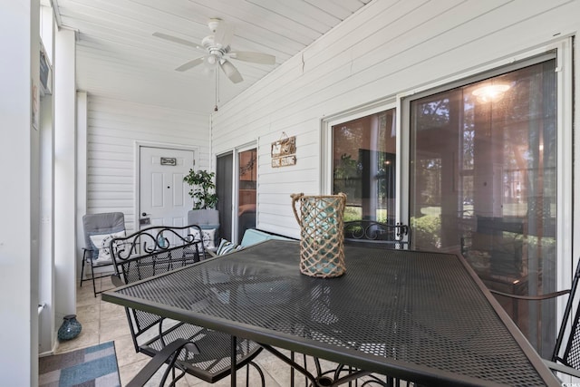 sunroom with ceiling fan and outdoor dining area