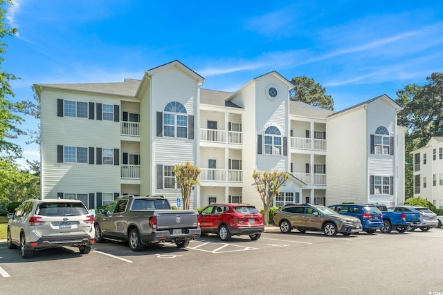 view of building exterior with uncovered parking