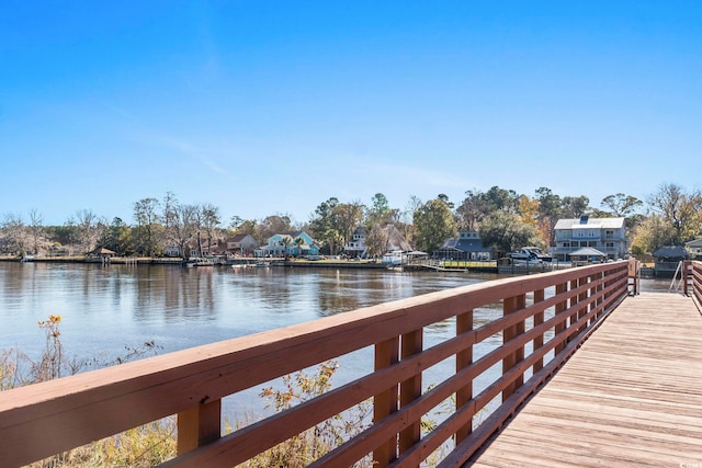 view of dock featuring a water view and a residential view