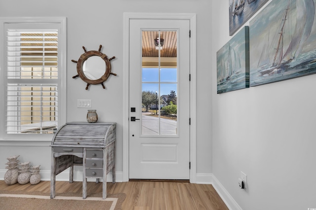 entryway featuring baseboards and wood finished floors