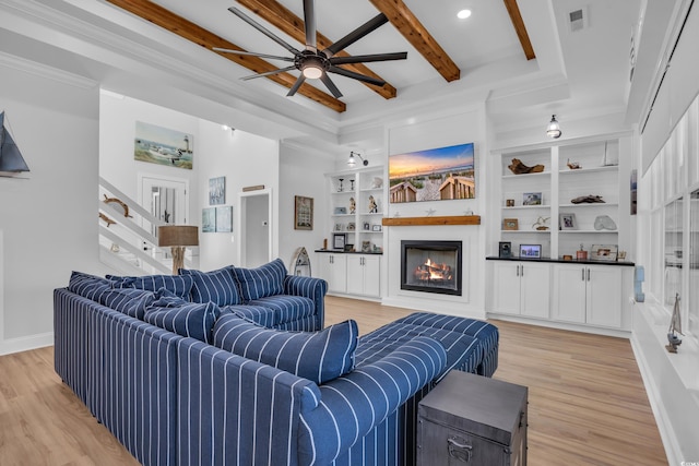 living room with visible vents, a ceiling fan, light wood finished floors, and a lit fireplace
