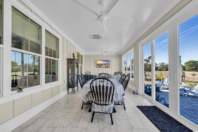 sunroom / solarium with ceiling fan, visible vents, and plenty of natural light