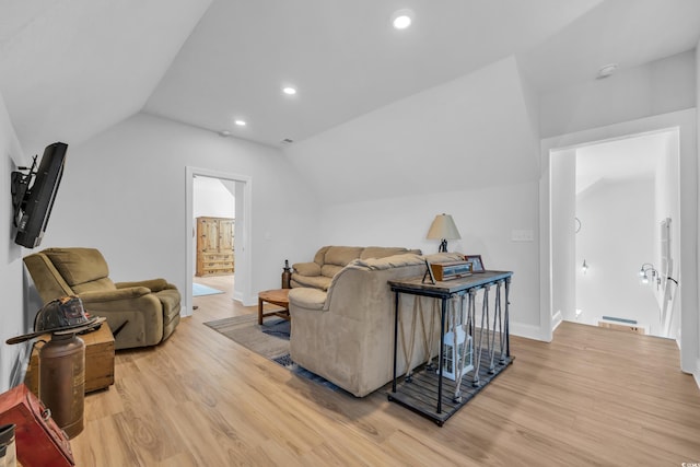 living area featuring baseboards, recessed lighting, light wood-style flooring, and vaulted ceiling