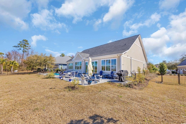 back of property with a lawn, a fenced backyard, and board and batten siding