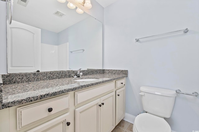 bathroom featuring baseboards, vanity, toilet, and visible vents