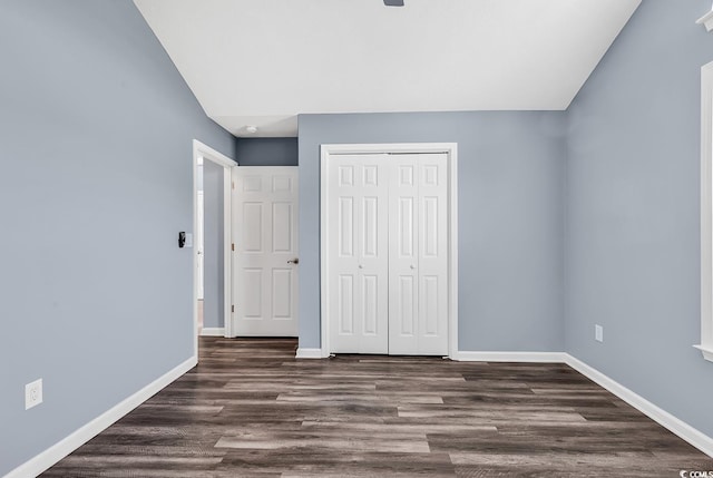 389 Barton Loop, Myrtle Beach, SC 29579 - unfurnished bedroom featuring baseboards, a closet, and dark wood-style floors
