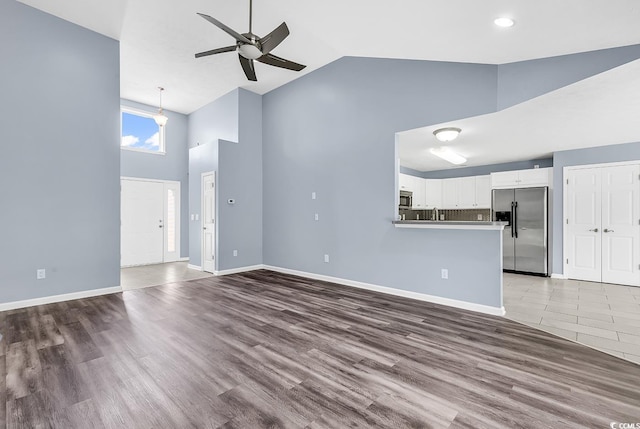 389 Barton Loop, Myrtle Beach, SC 29579 - unfurnished living room featuring high vaulted ceiling, a ceiling fan, wood finished floors, baseboards, and recessed lighting
