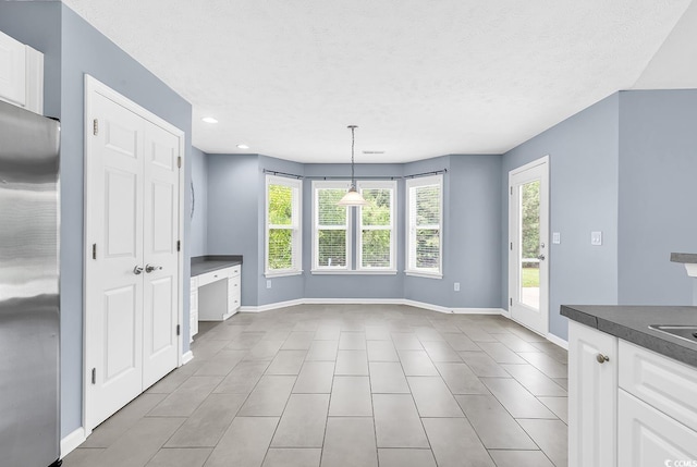 389 Barton Loop, Myrtle Beach, SC 29579 - unfurnished dining area featuring tile patterned flooring, baseboards, recessed lighting, and a textured ceiling