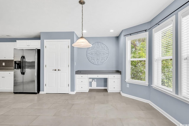 389 Barton Loop, Myrtle Beach, SC 29579 - kitchen featuring stainless steel fridge with ice dispenser, white cabinetry, tasteful backsplash, light tile patterned floors, and pendant lighting